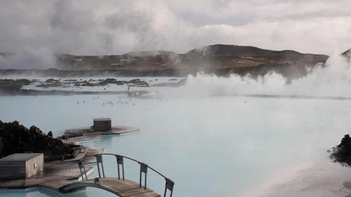 view of blue lagoon in iceland with a bridge in corner