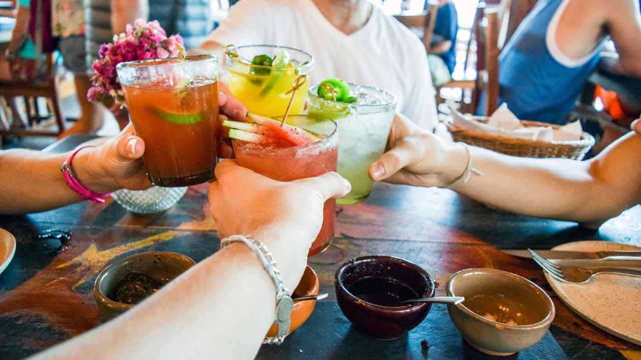 group of people with drinks in tulum
