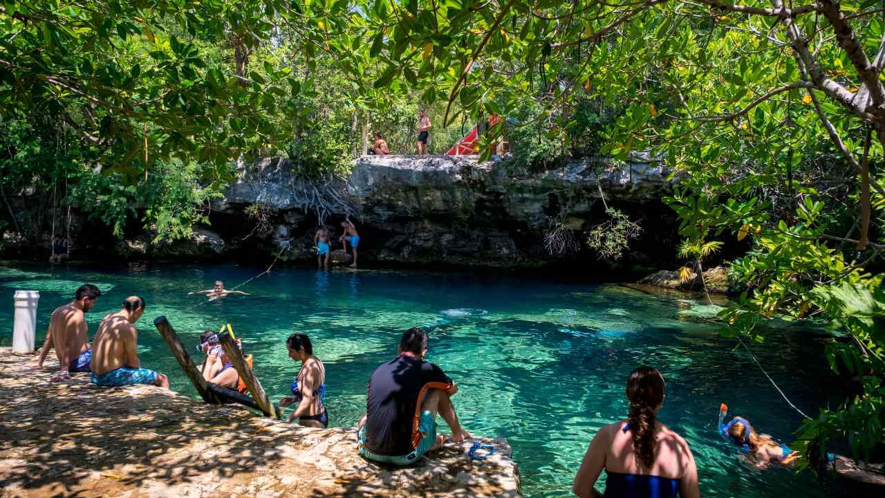 tourist at cenote cristalino