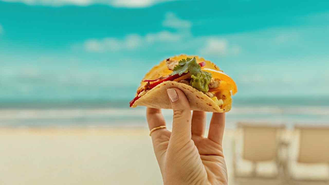 taco with tulum beach in background 