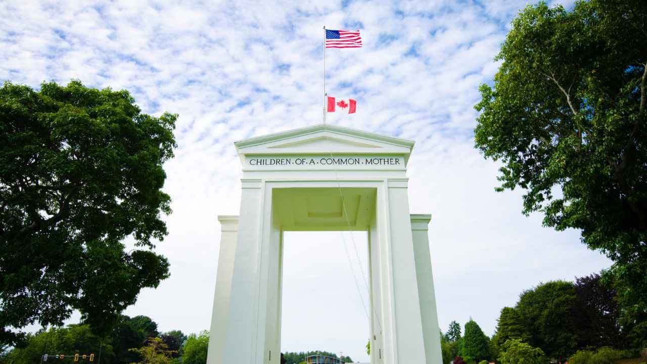 a white arch with a canadian flag on top of it