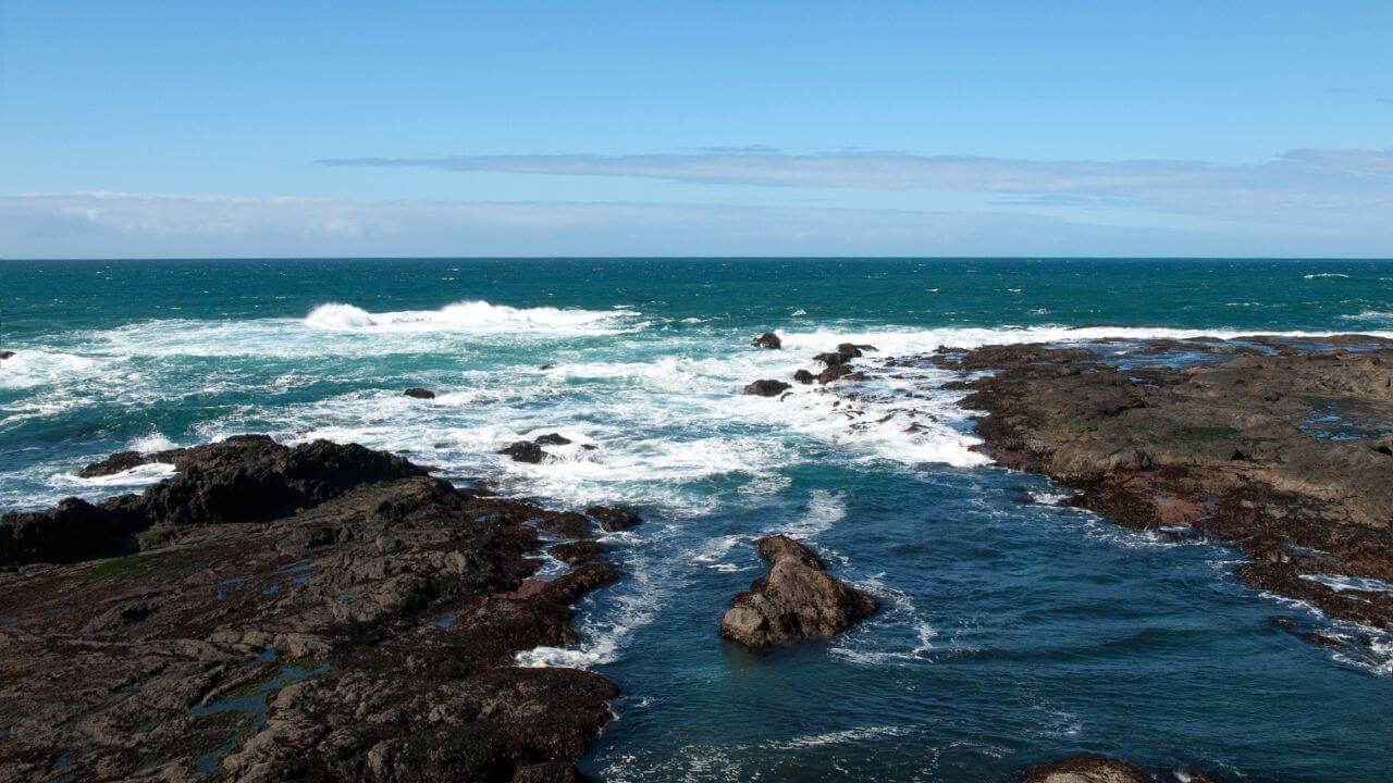 rocky coastline with waves crashing into the ocean