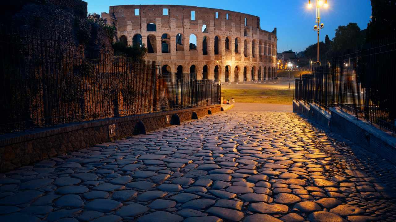 cobble stone walkway towards the colosseum in rome