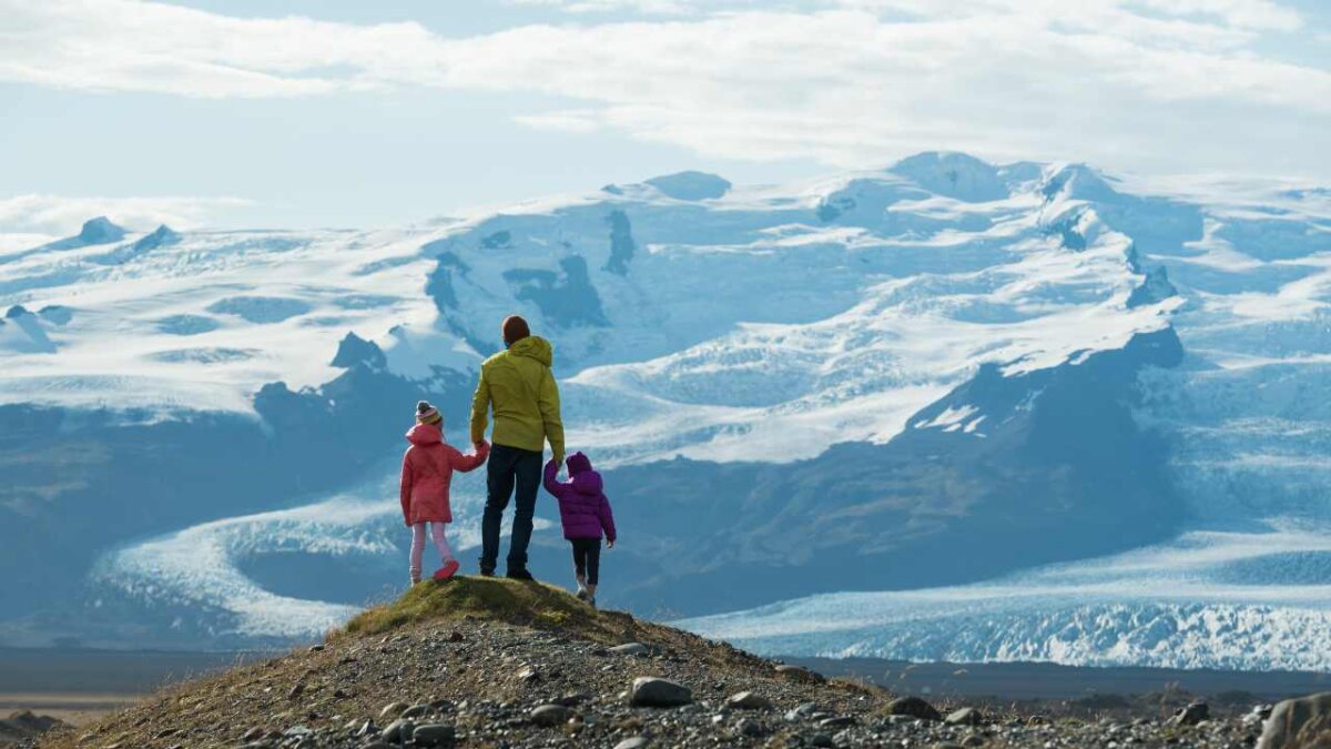 family traveling in iceland looking at glaciers
