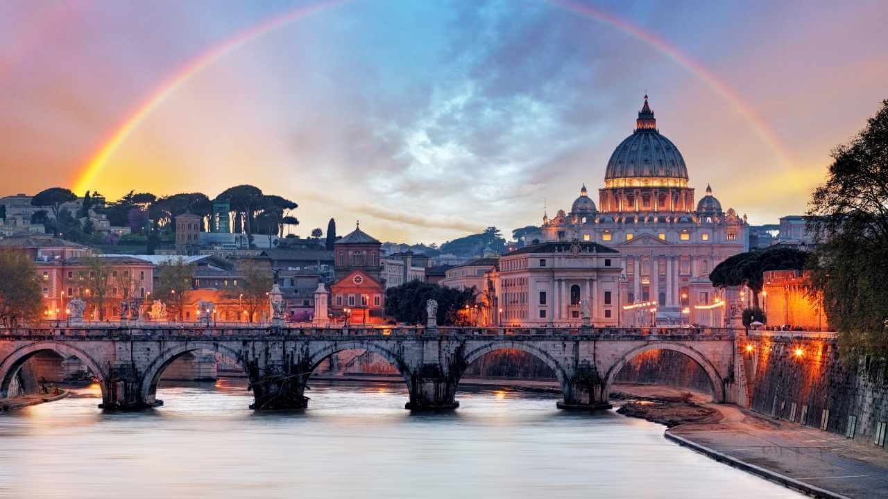 view of rome at sunset with a rainbow