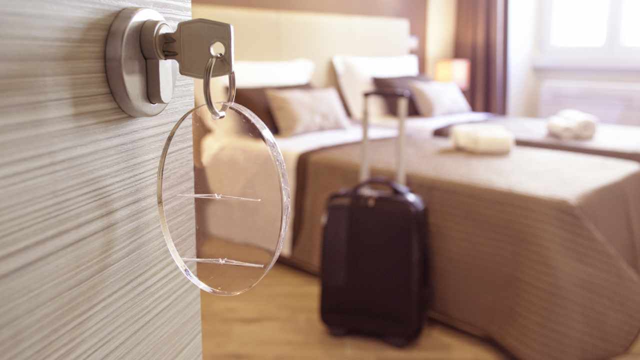 inside a hotel room with suitcase and bed