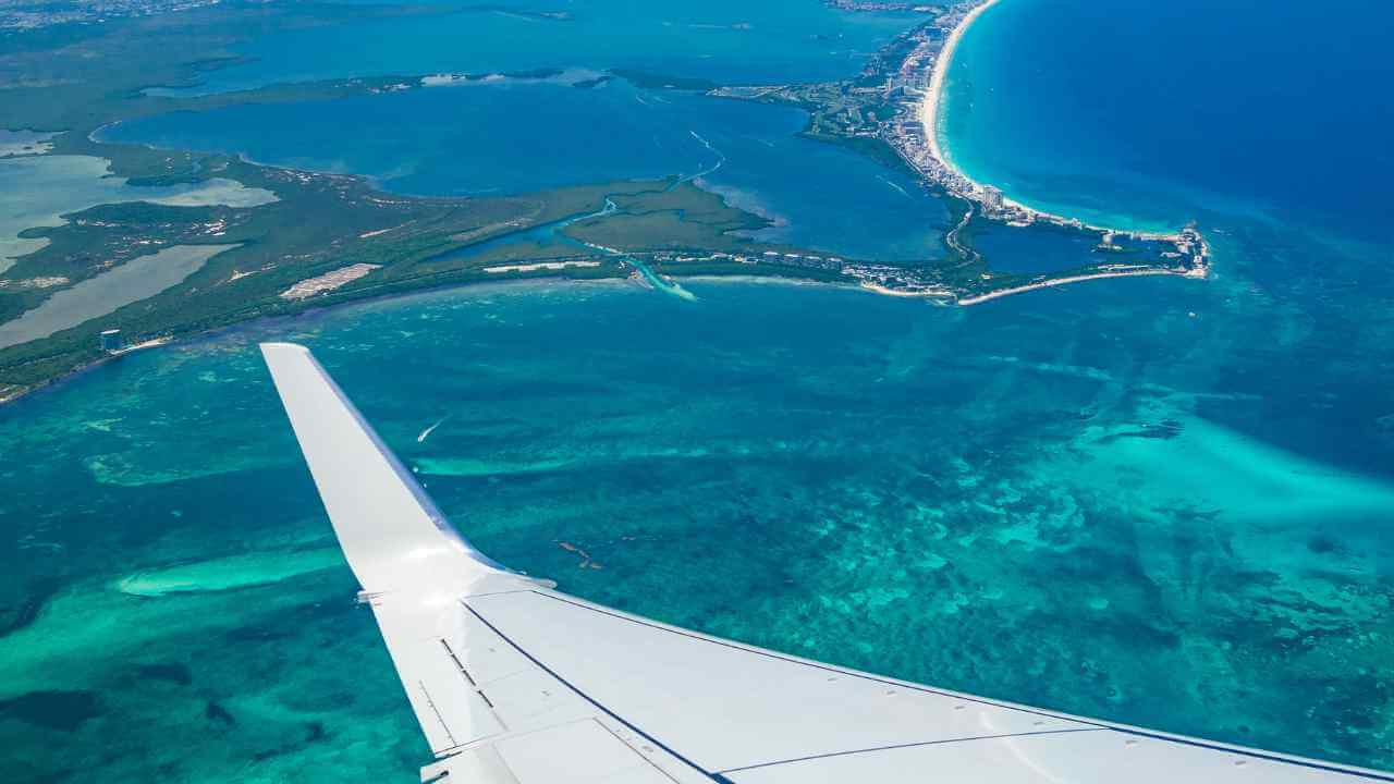 picture of plane flying over cancun