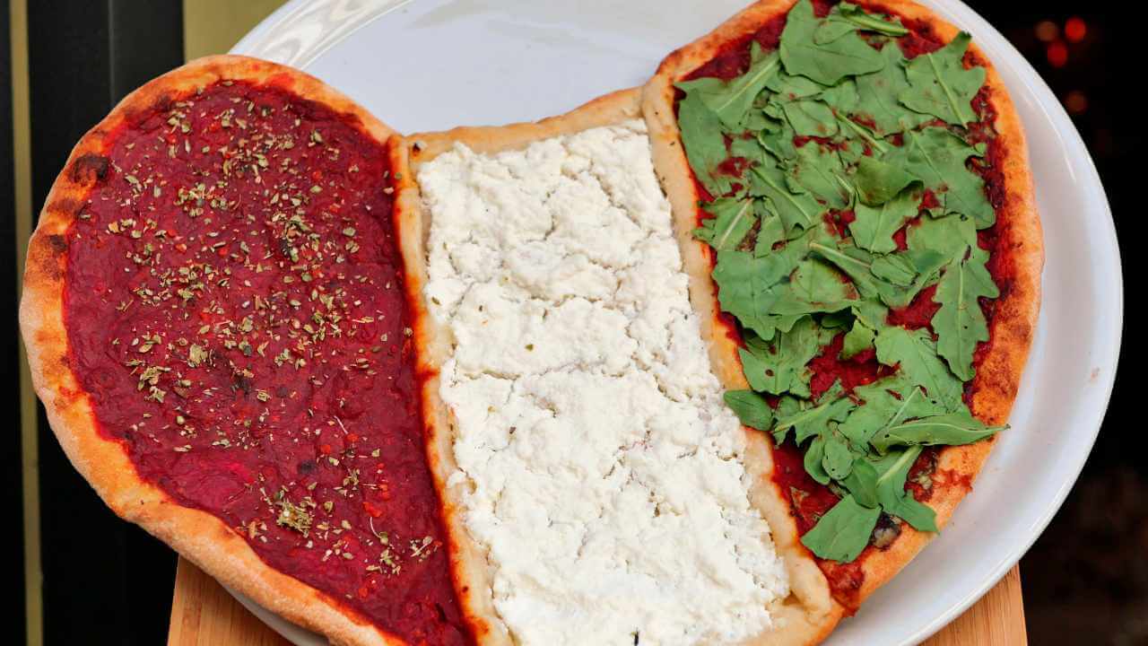 pizza shaped in a heart and replicating the italian flag