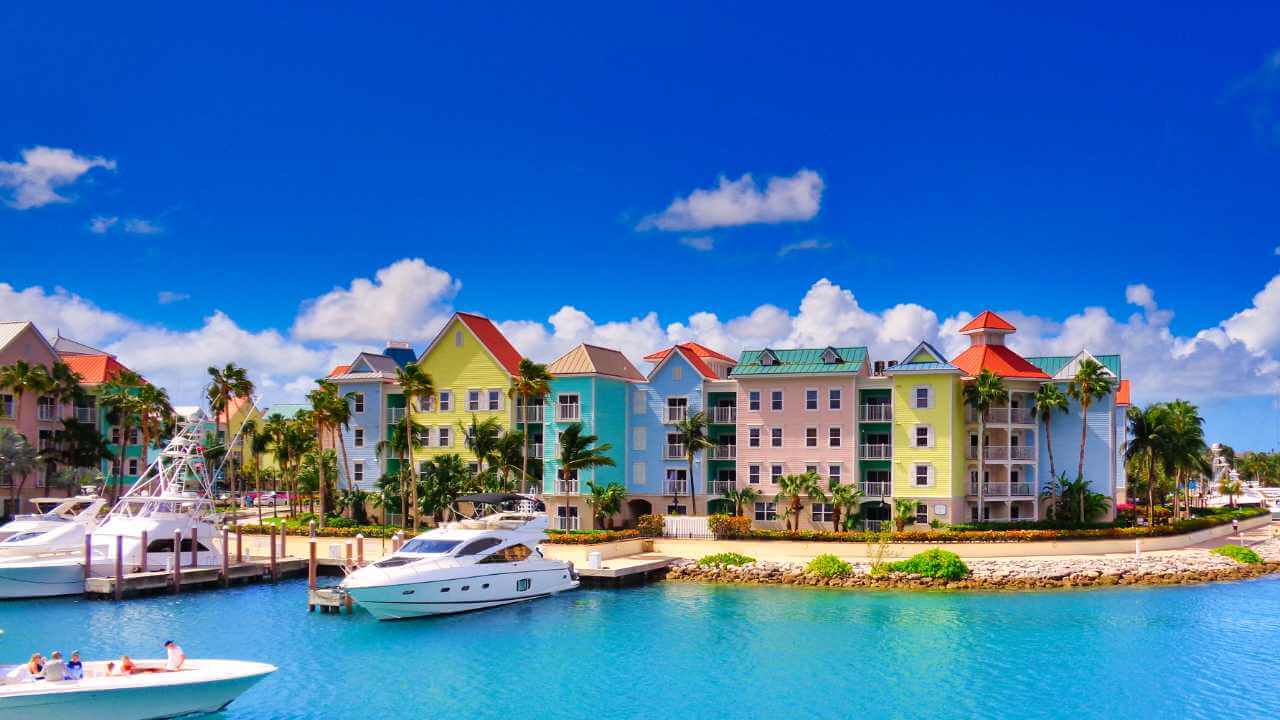  colorful buildings and boats docked in the water in the bahamas