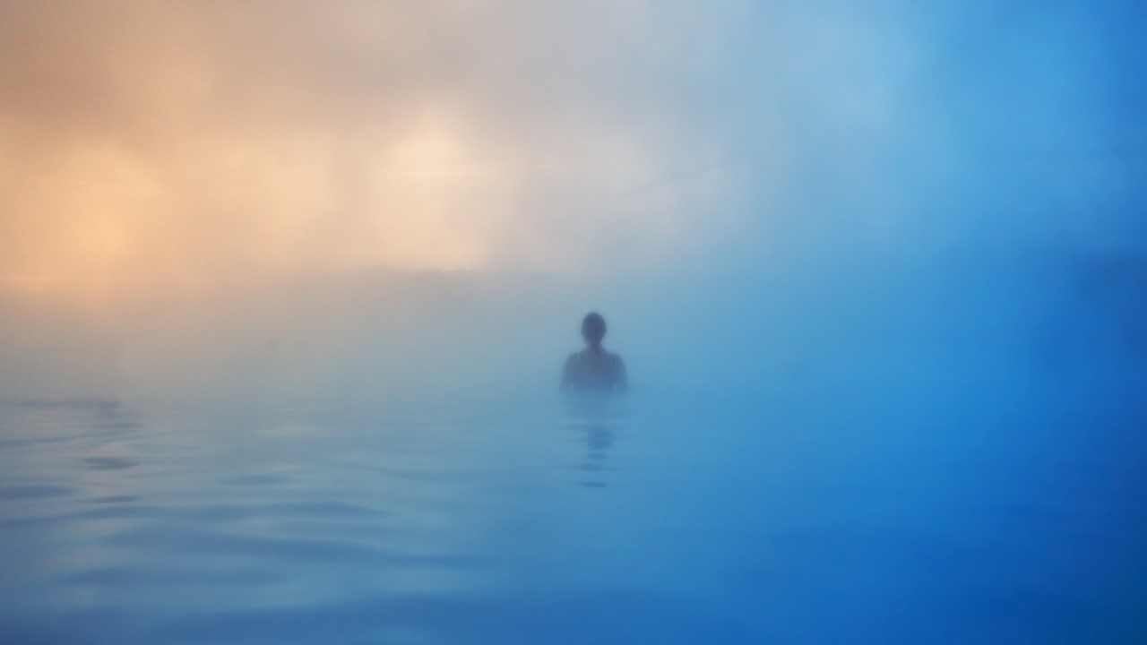 person overlooking moutains from the blue lagoon