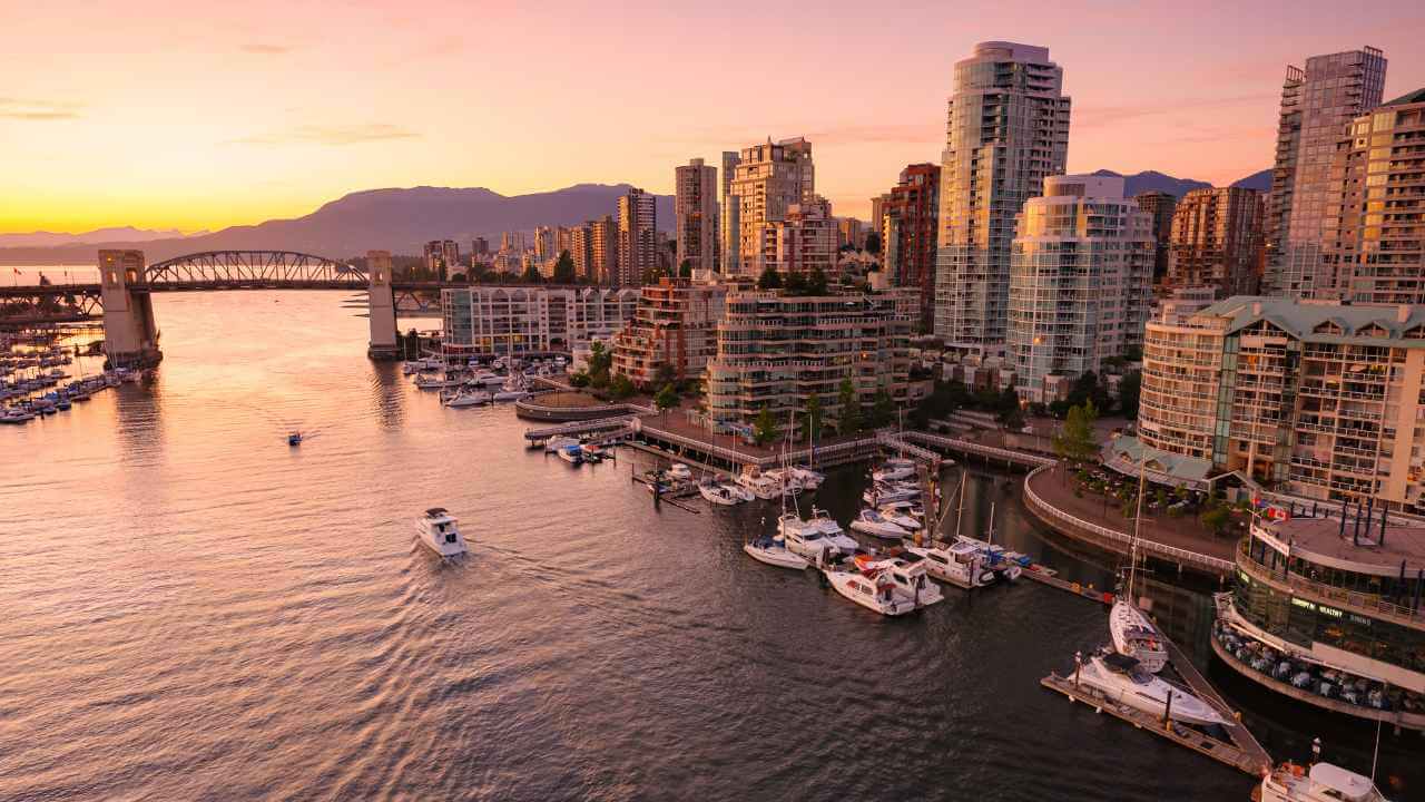 an aerial view of the city of vancouver, british columbia, canada at sunset