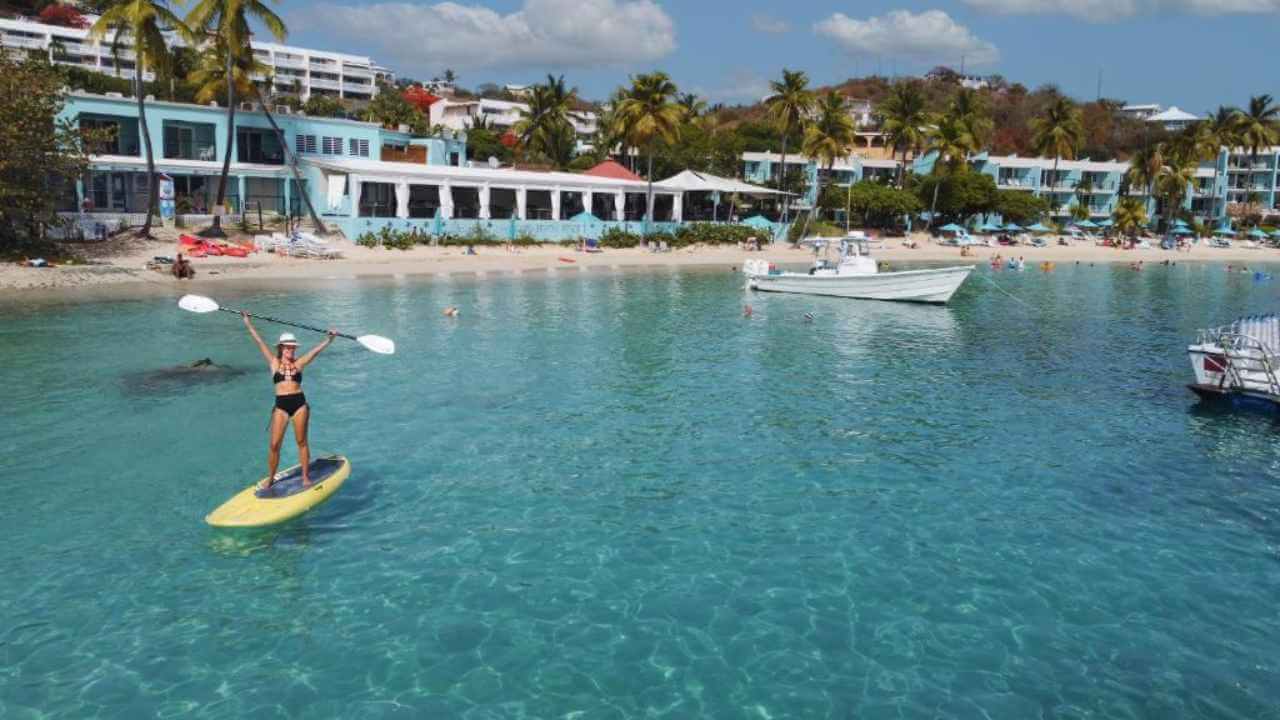 woman paddle boarding on the ocean front of secret harbour beach resort