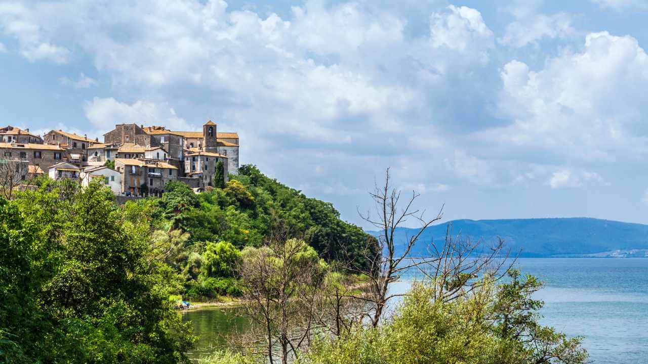 lake of bracciano in the background with buildings on hilltop