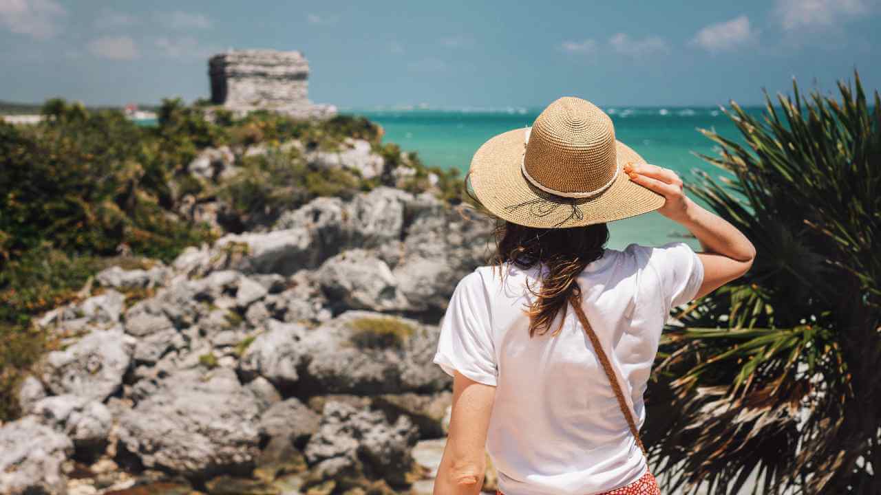 woman tourist in tulum looking at the ocean 