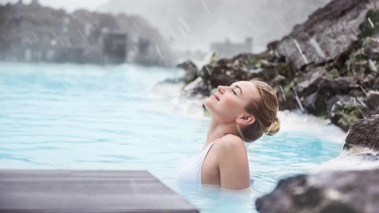 woman relaxing in the blue lagoon and taking it all in
