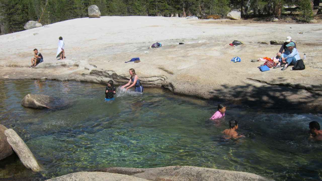 people in lake at a campground near yosemite