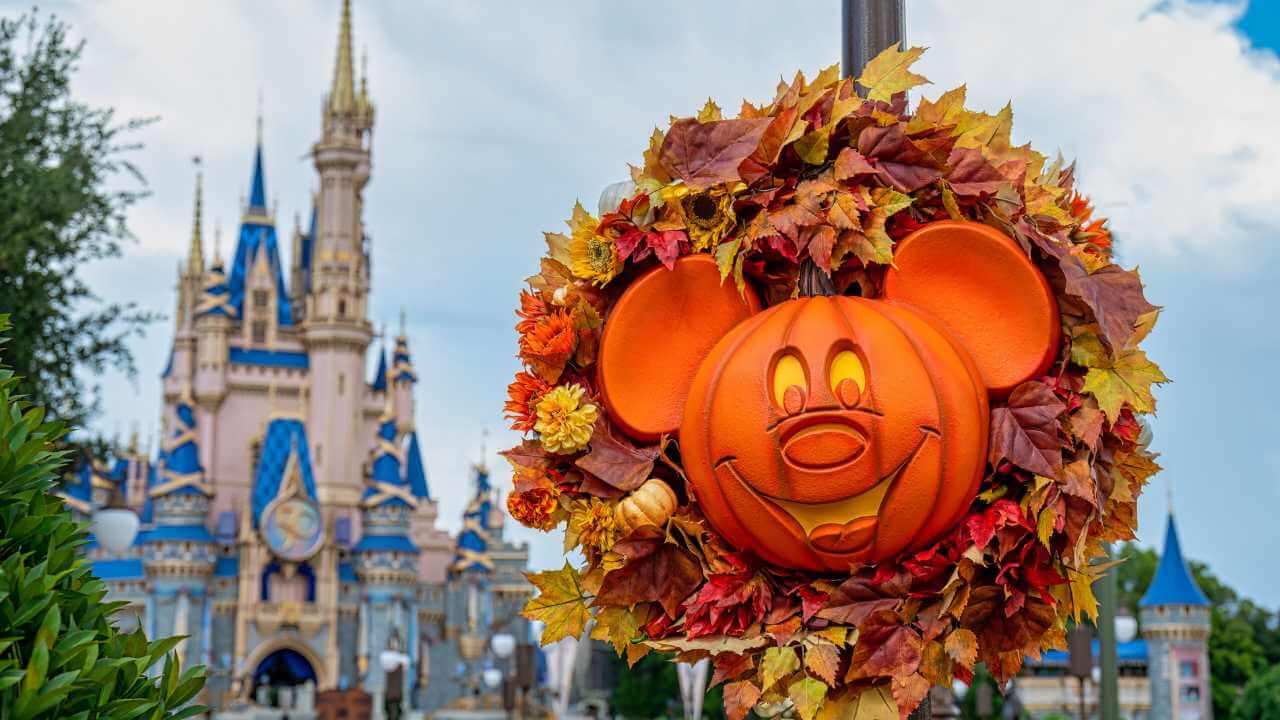 fall time decorations at magic kingdom, orange pumpkin shaped into a mickey wreath