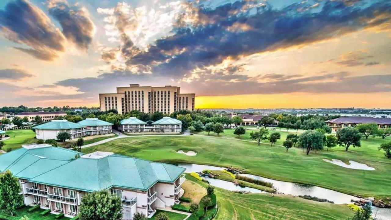 view of ritz carlton in dallas with there golf course and pool during the sunset