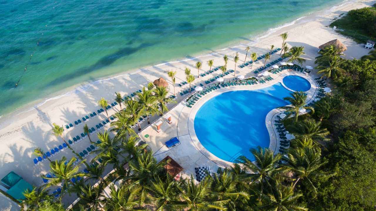 overview of the occidental cozumel pool in mexico with the beach right outside of the pool