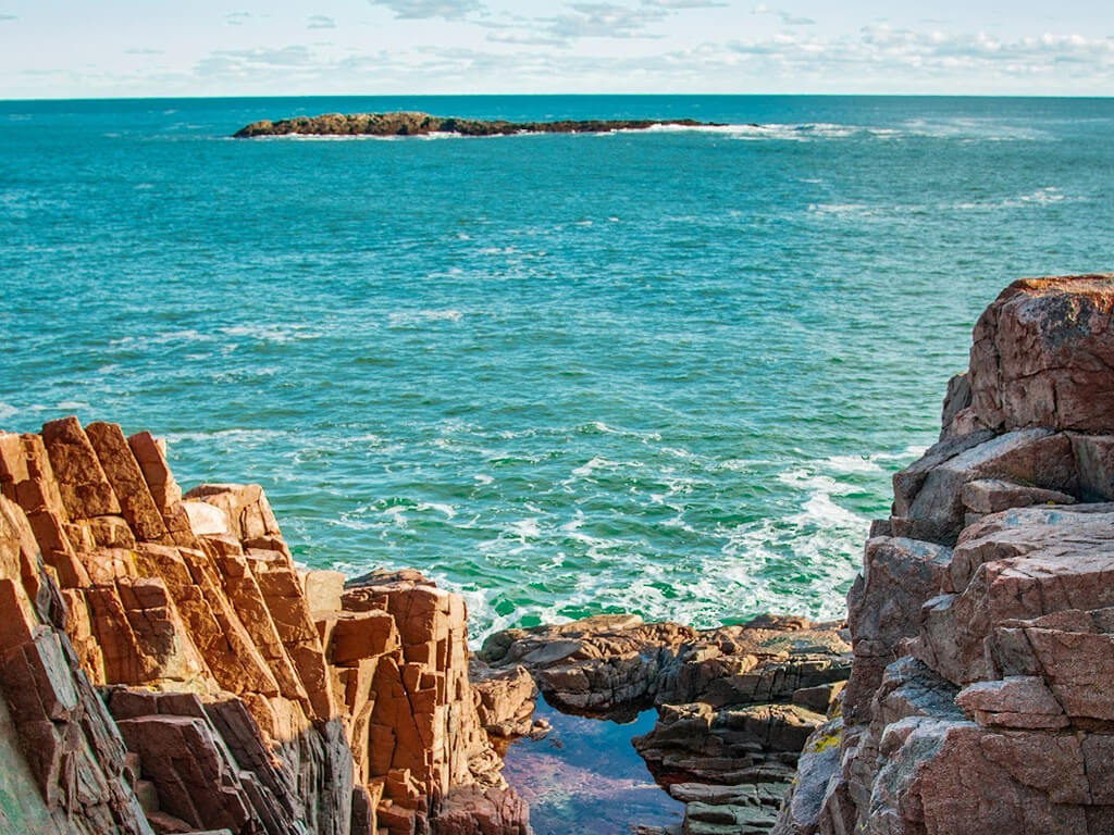 Blue waters lapping against rocks in Acadia National Park, Maine