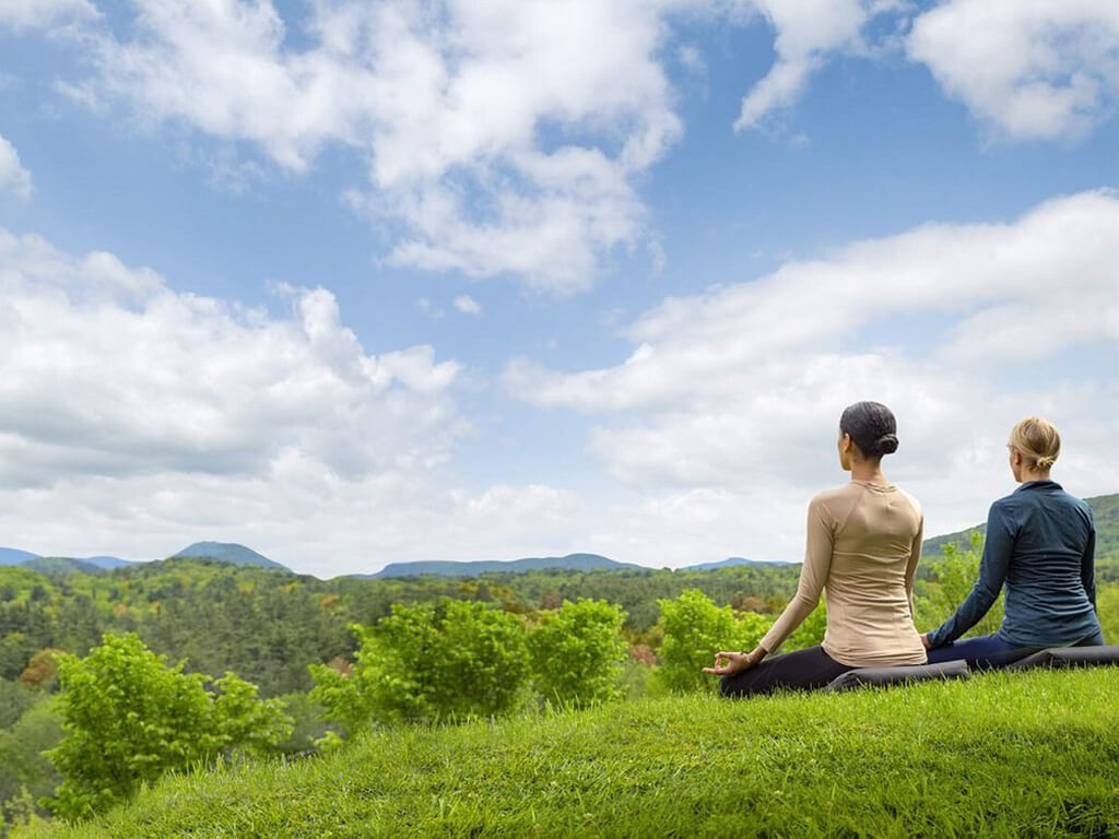 Yoga in the grasses of the Kripalu Center