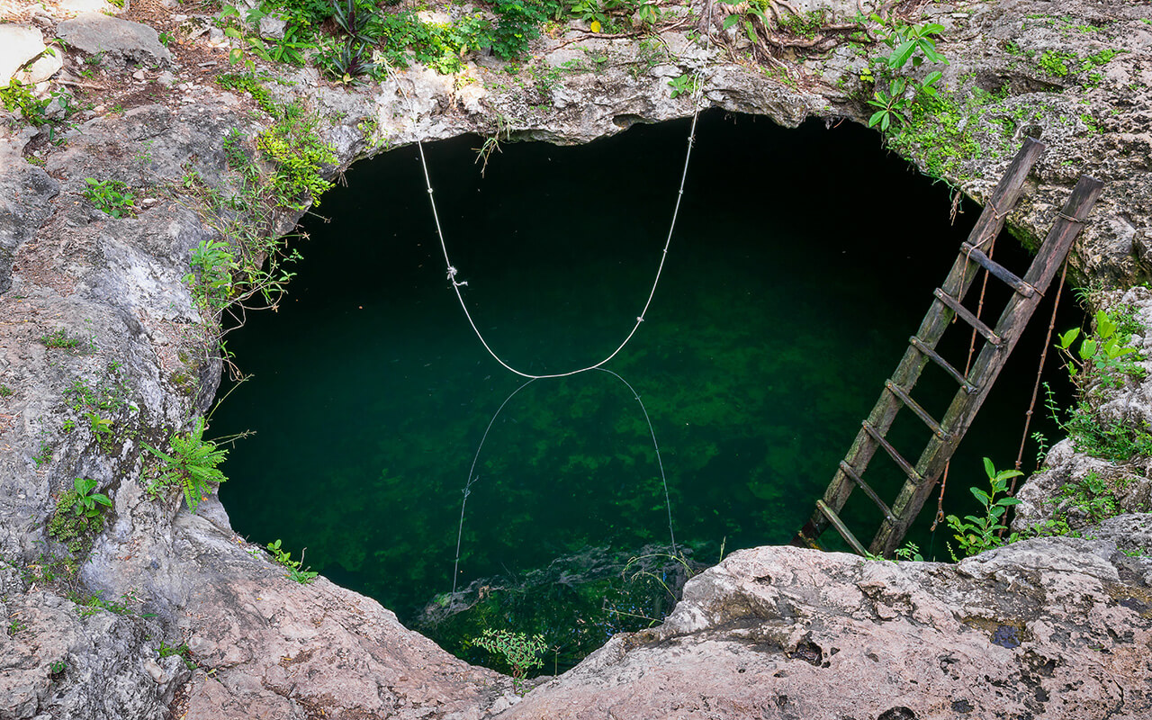 Closeup shot of the Cenote Calavera tourist attraction in Tulum, Mexico