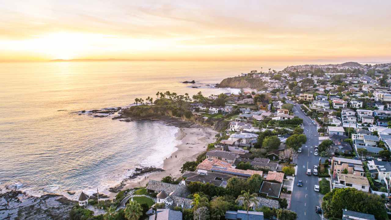 an aerial view of a coastal town at sunset