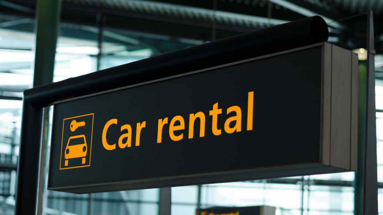 a car rental sign is shown in an airport