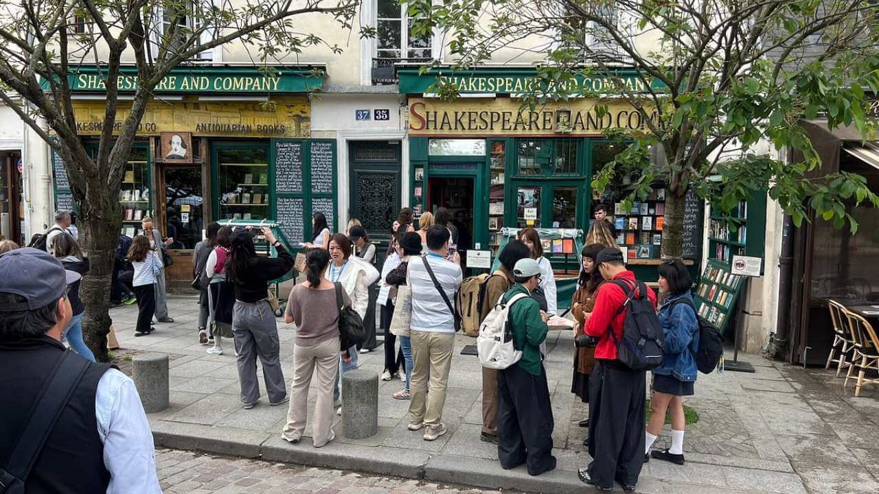 a group of people standing in front of a book store