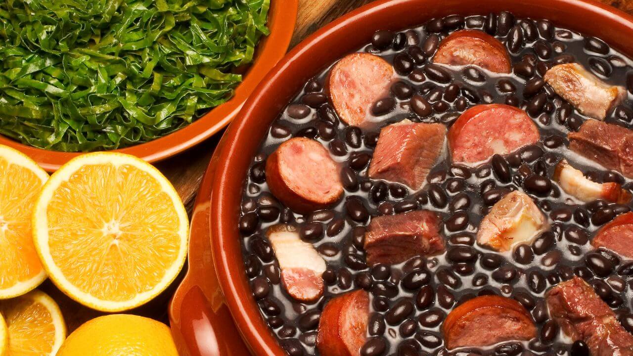a bowl filled with black beans, sausage and lemons