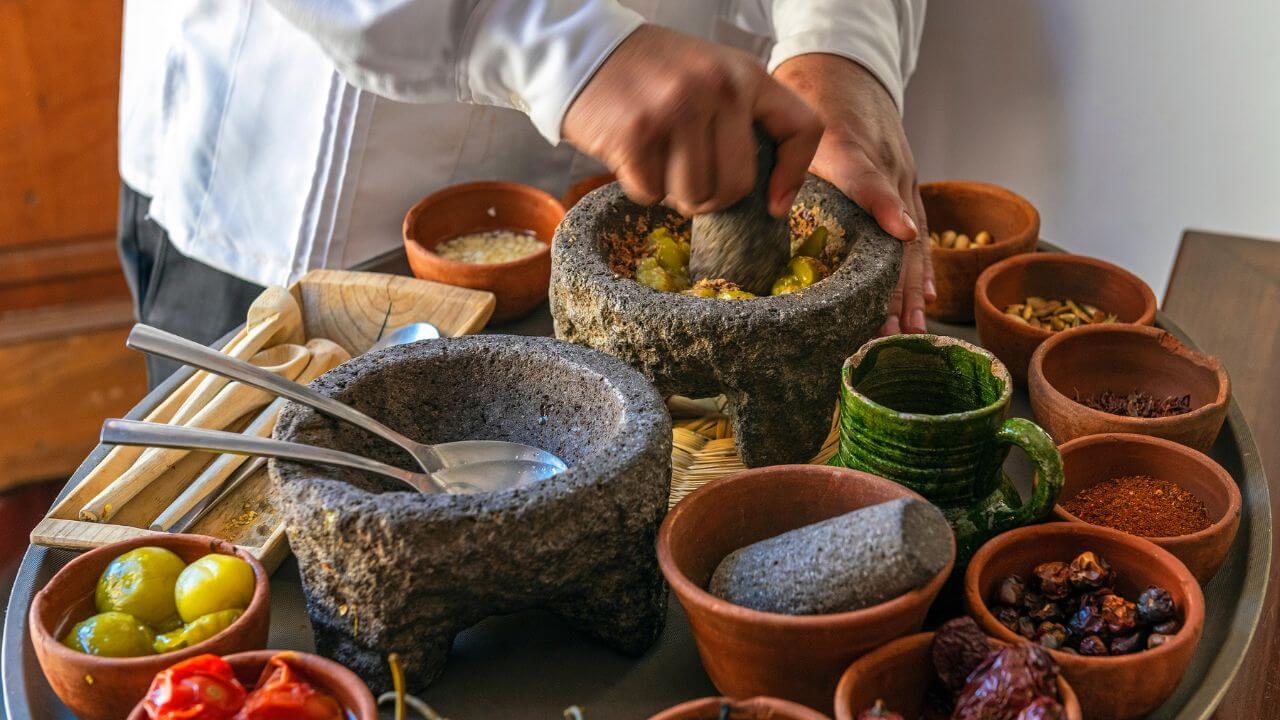 a chef preparing food in a mortar and pestle