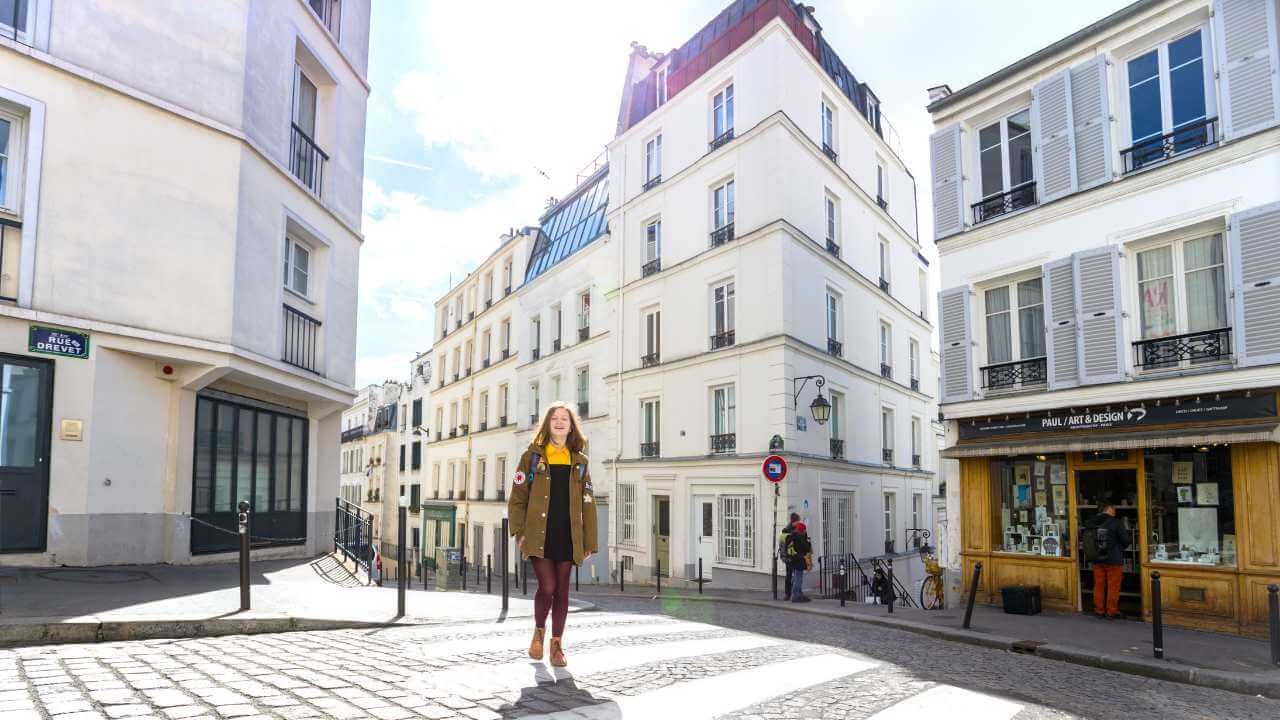 a person is walking down a narrow street in paris
