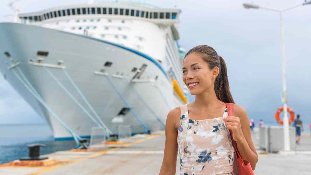a person is standing in front of a cruise ship
