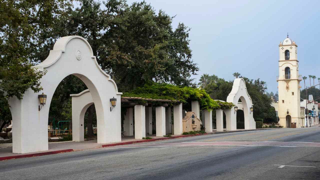 a white building with arches and a clock tower