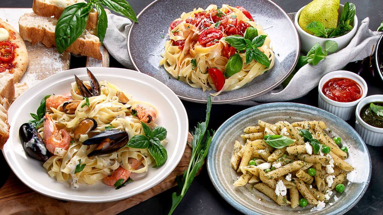 a variety of pasta dishes on a table