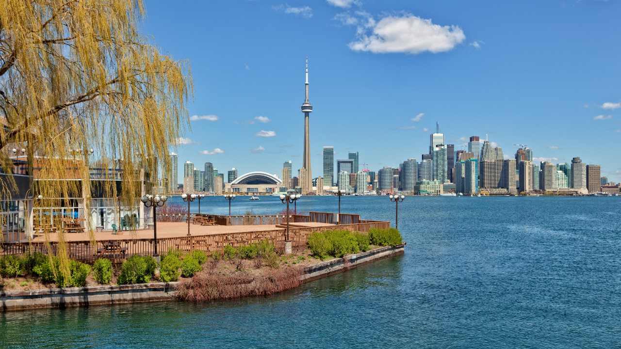 the toronto skyline is seen from across the water