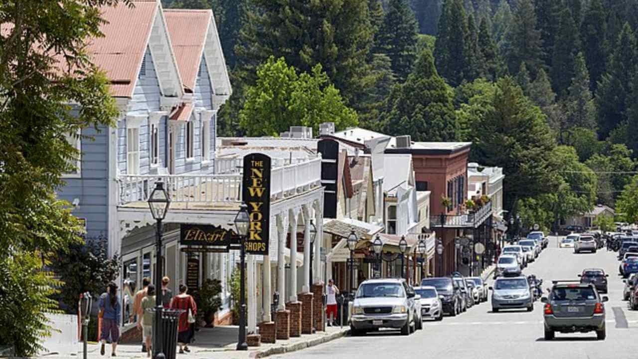 a city street with cars parked on both sides of the road