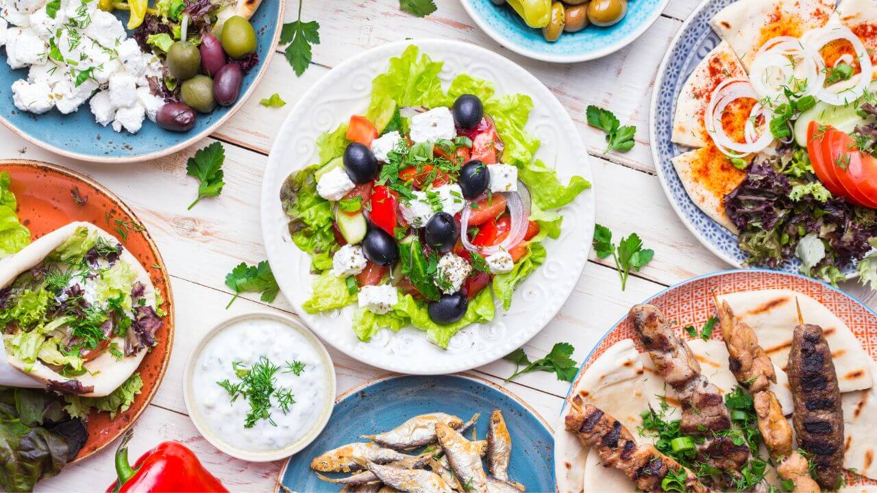 various types of greek food on plates
