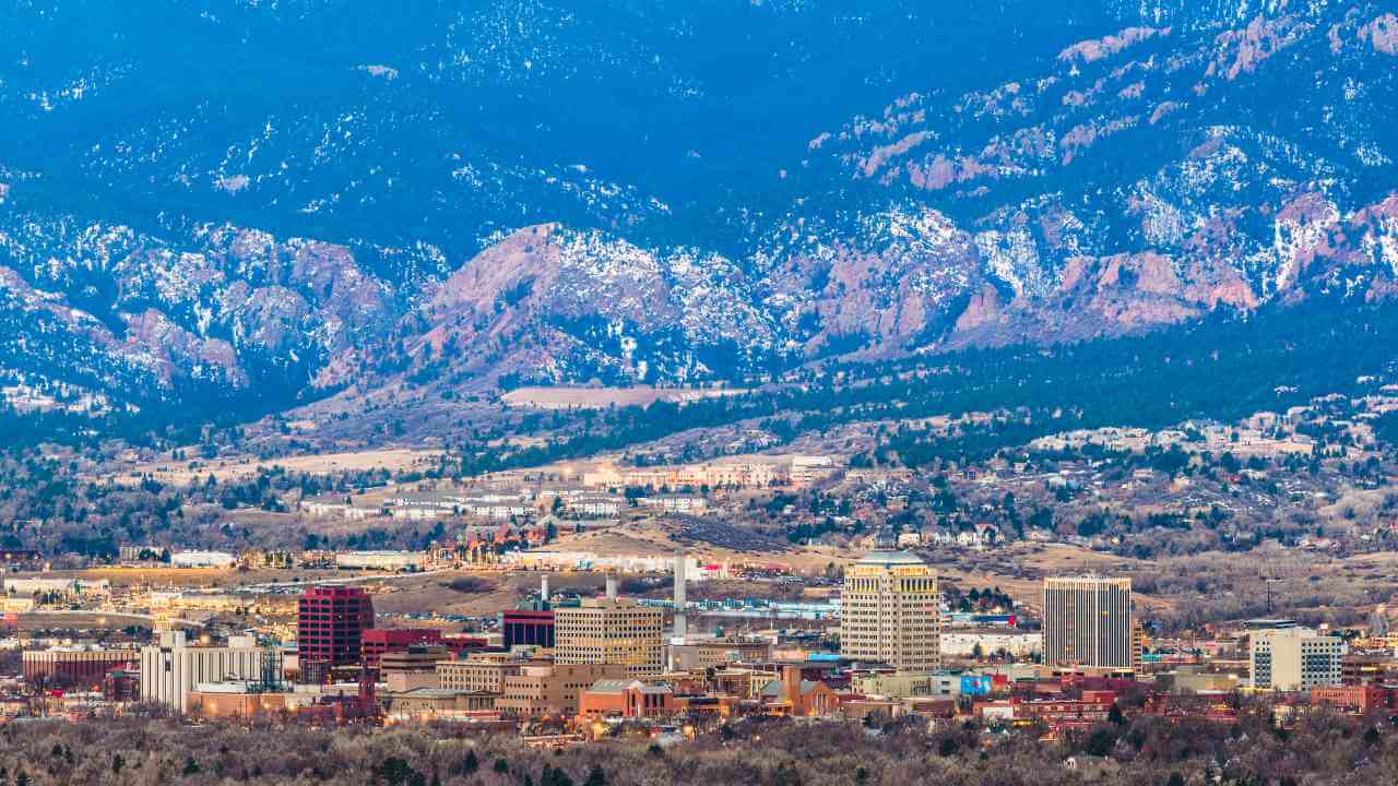 the city of colorado with mountains in the background