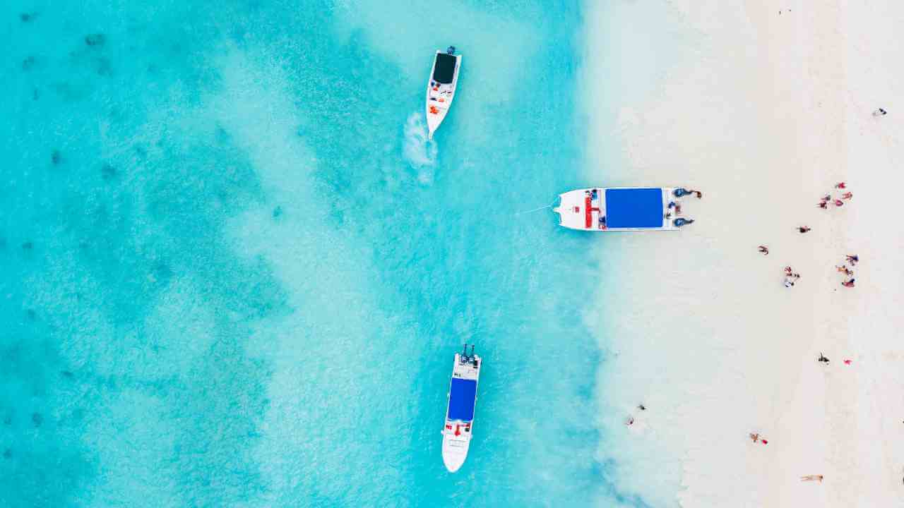 An aerial view of boats and people on a beach