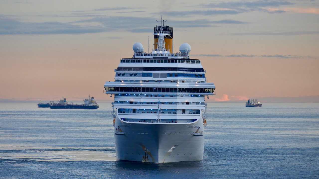 cruise ship coming towards you with sunset in back