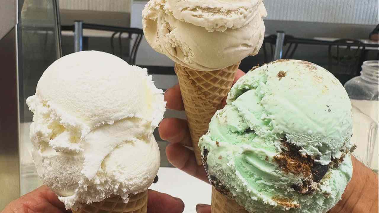 three different flavors of ice cream are being held in someone's hand