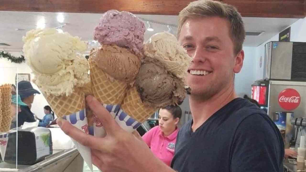 a person is holding up a bunch of ice cream