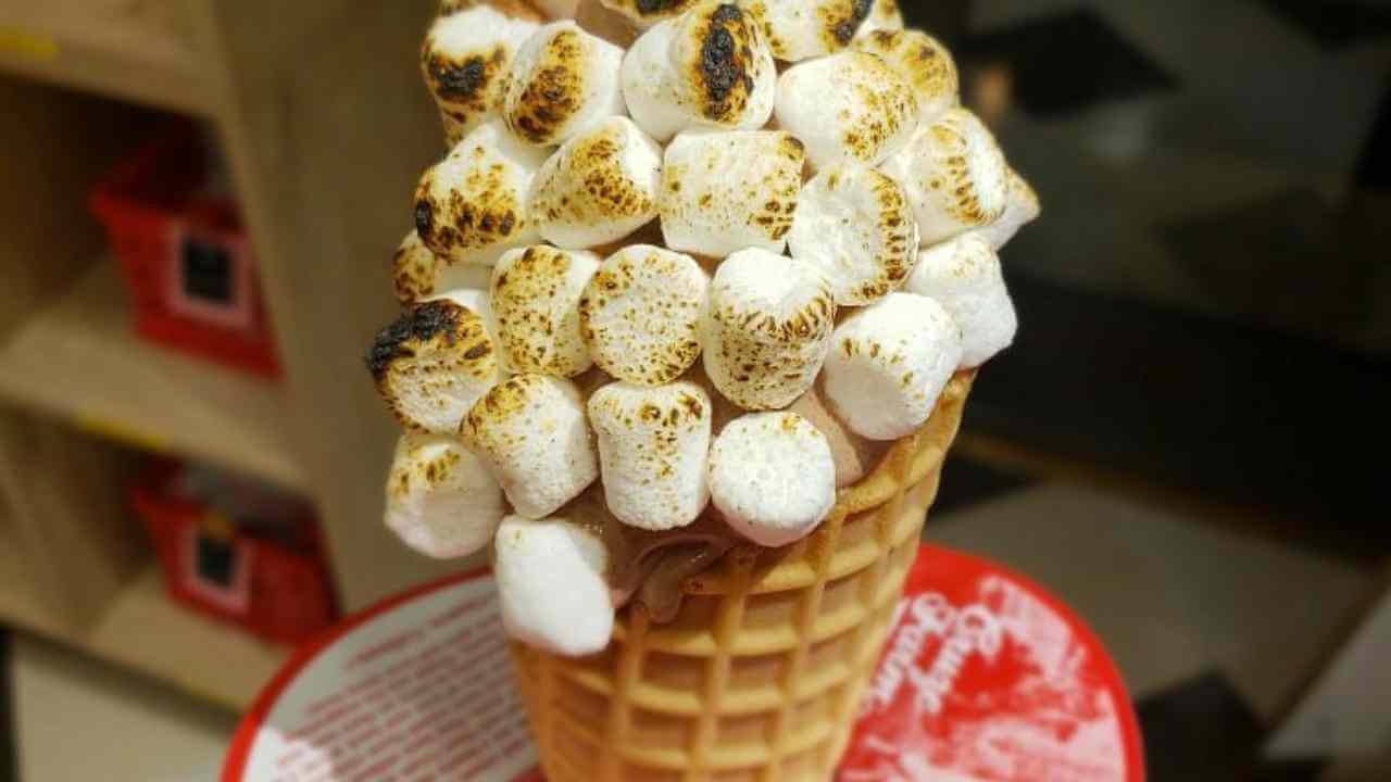 an ice cream cone with marshmallows on top
