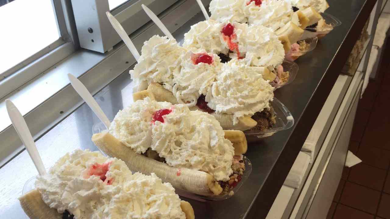 several banana splits are lined up on a counter