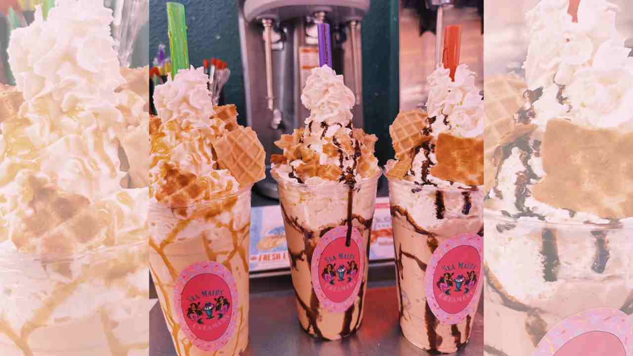 three ice cream sundaes with toppings sit on top of a counter