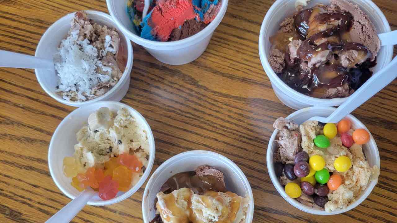 several bowls of ice cream sitting on top of a wooden table