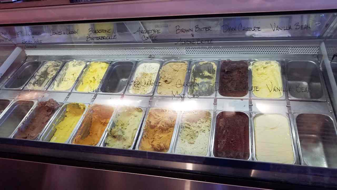 an ice cream display case with many different types of ice cream