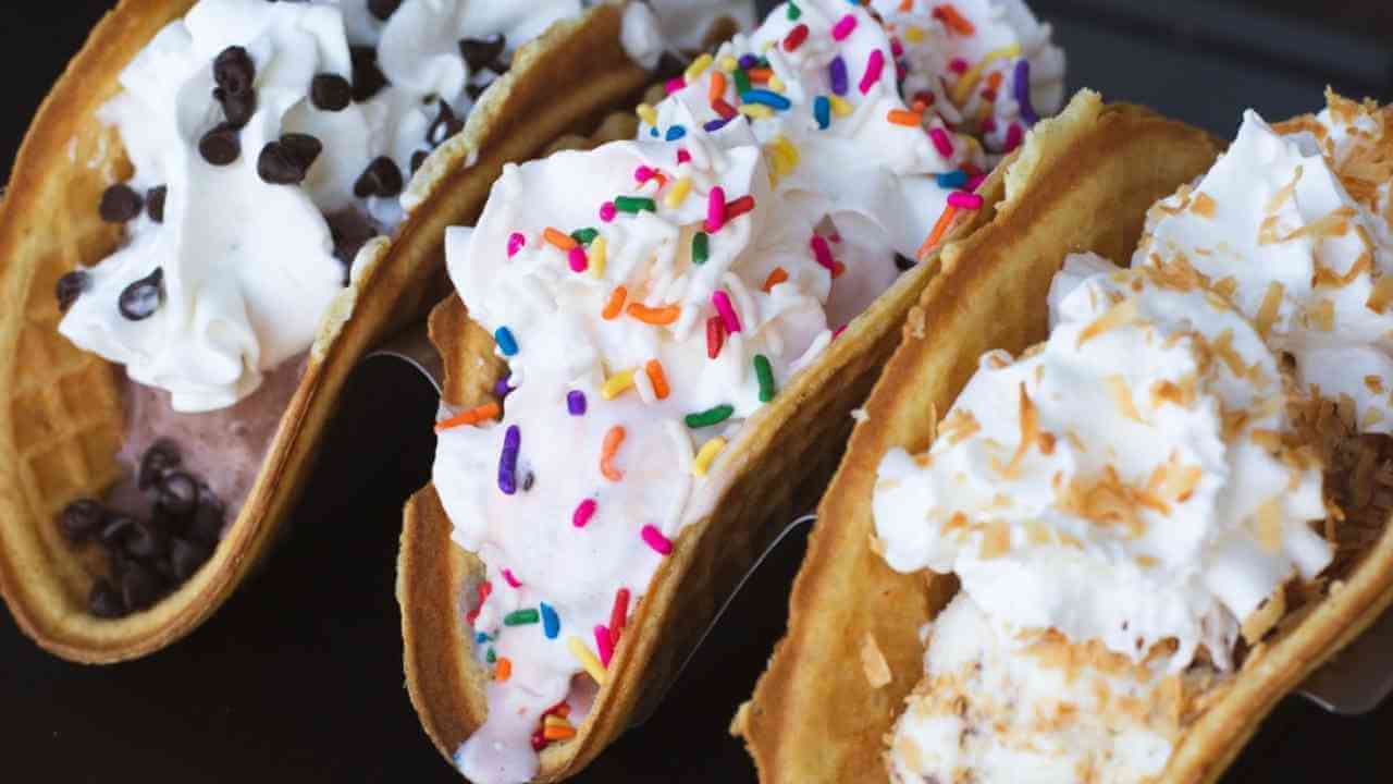 three waffle tacos with whipped cream and sprinkles