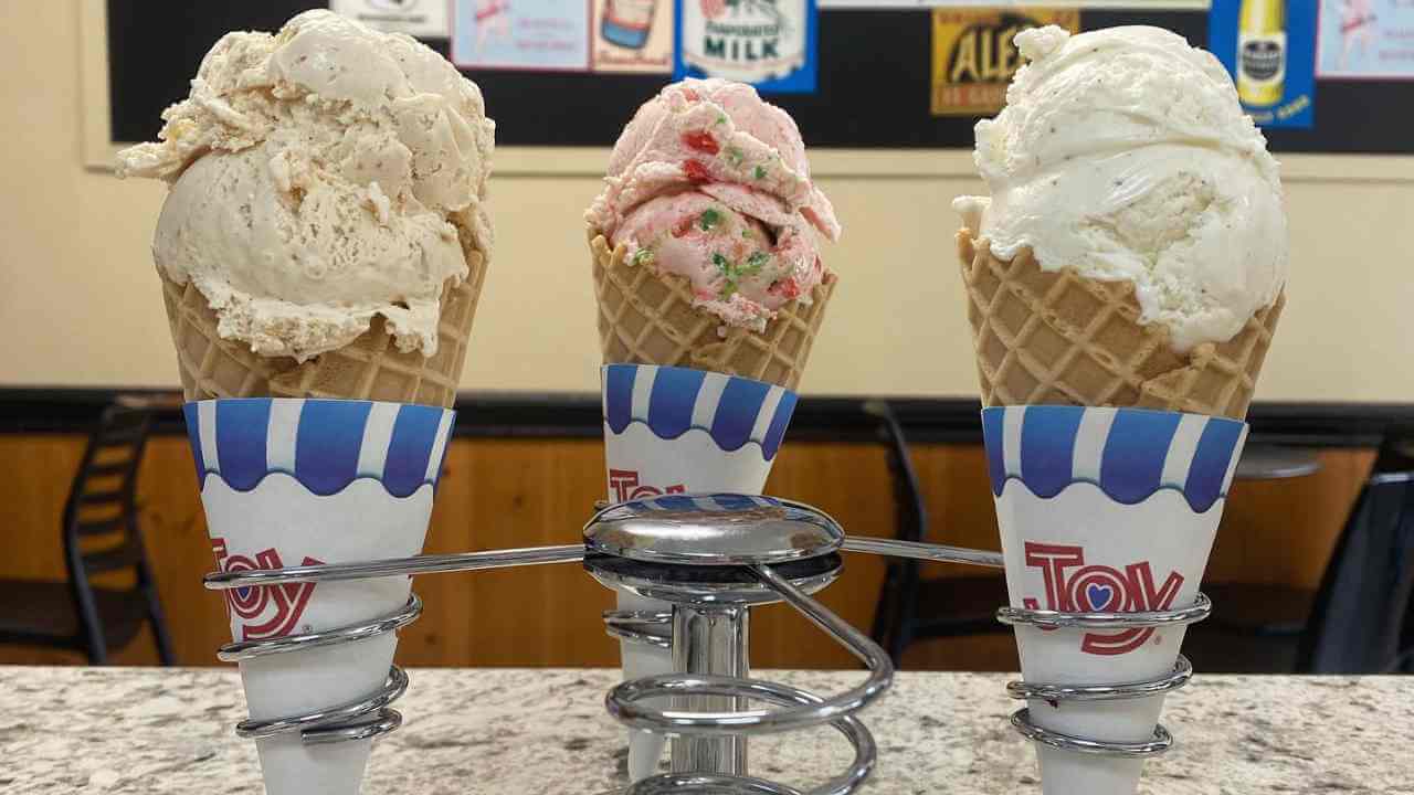 three ice cream cones sitting on top of a counter